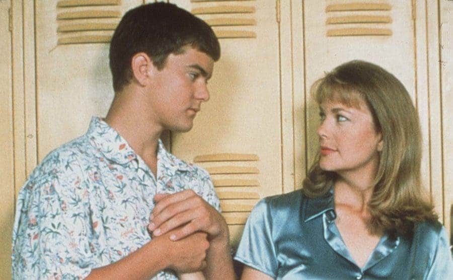 Joshua Jackson holding Leann Hunley’s hand standing in front of lockers
