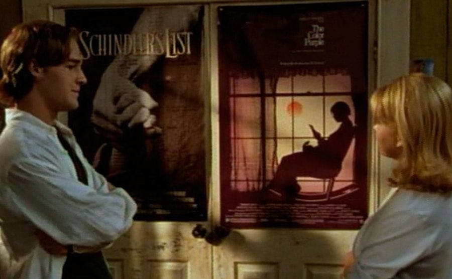 Dawson and Jen standing in front of movie posters
