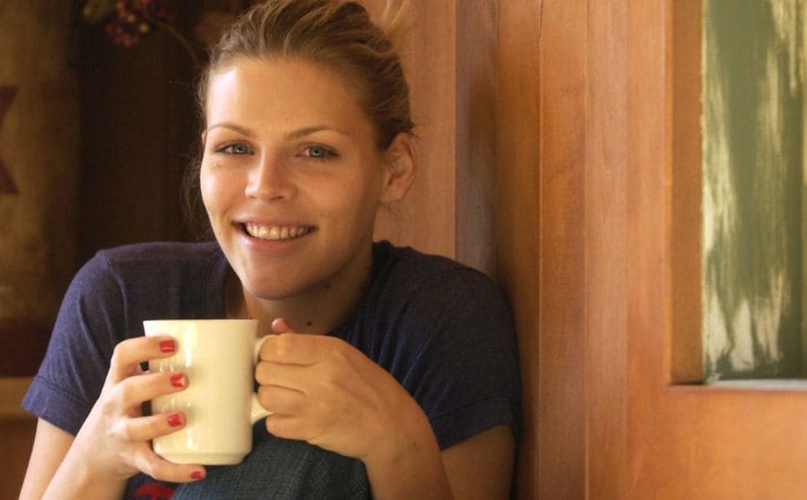 Busy Philipps sitting with a cup of coffee