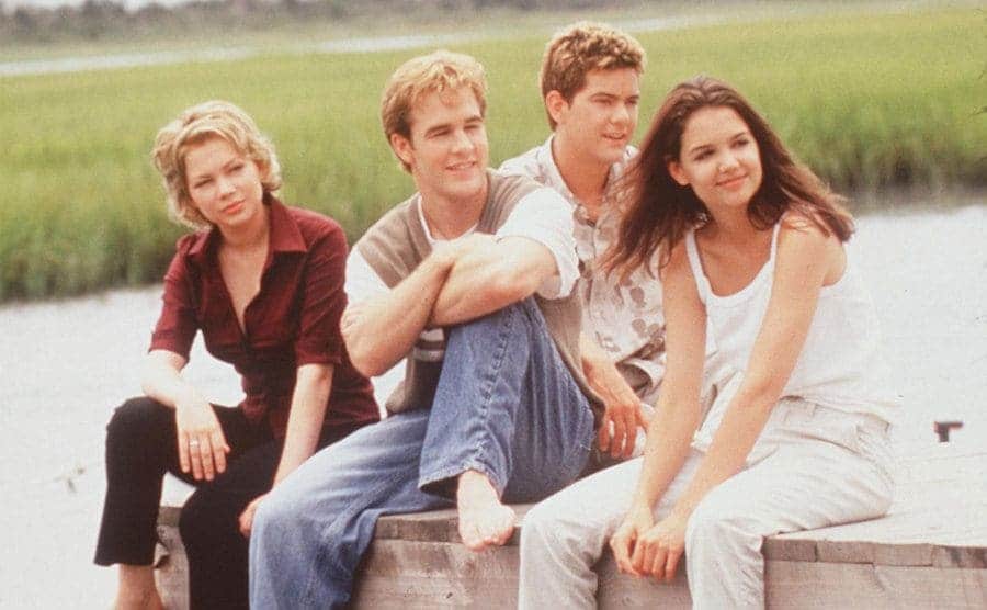 Michelle Williams sitting with Dawson, Pacey, and Joey on the pier