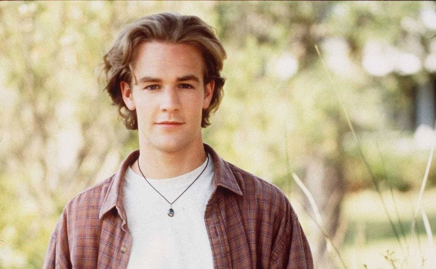 James Van Der Beek posing in a field