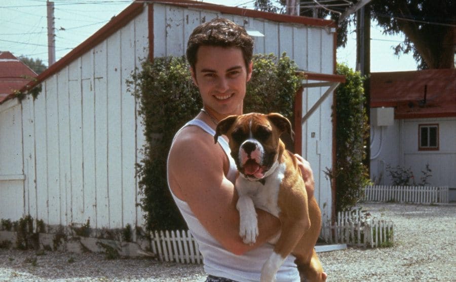 Kerr Smith holding a cute dog outdoors