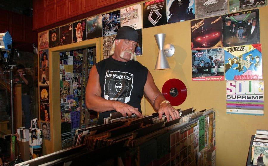 Hulk Hogan going through a rack of records 