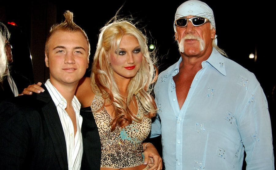 Nick, Brooke, and Hulk Hogan posing on the red carpet 