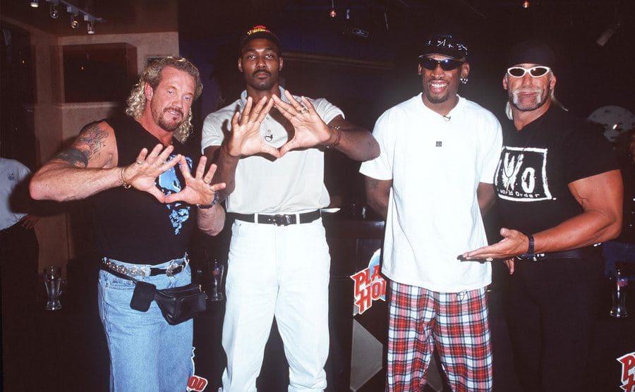 Hulk Hogan posing with Diamond Page, Karl Malone, and Dennis Rodman