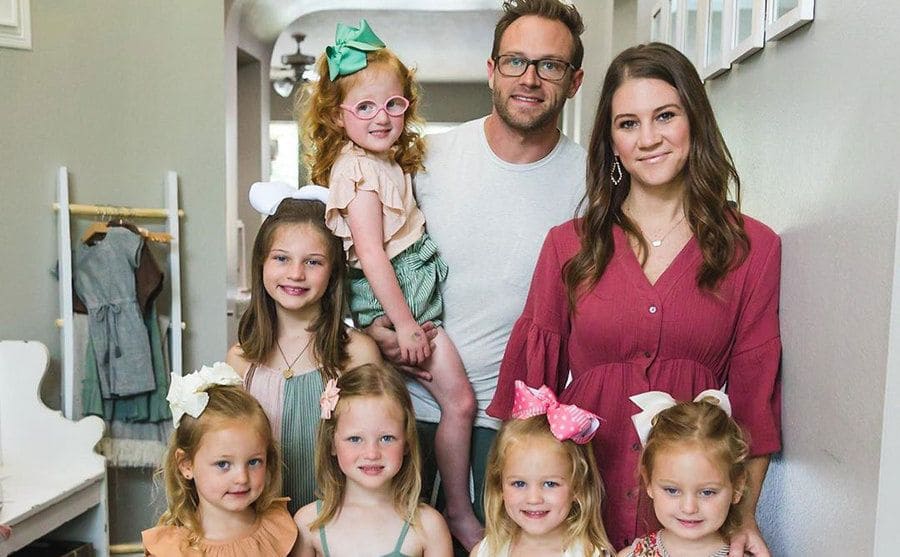 A family photo of Adam and Danielle Busby and their five daughters.