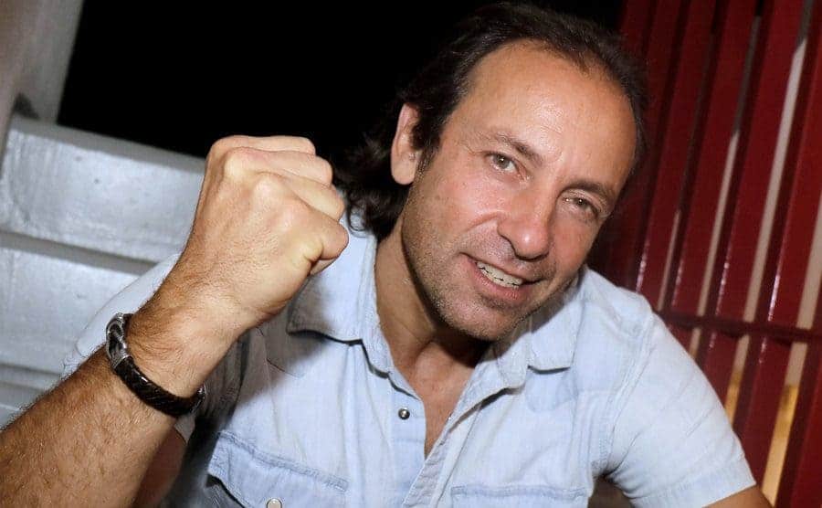 Philippe Candeloro photographed sitting on steps making a fist