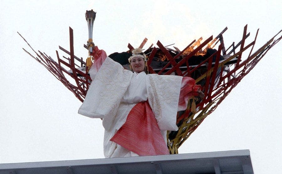 Midori Ito holding the torch at the 1998 Olympics after lighting the torch