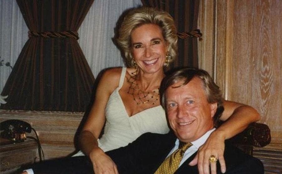 Maurizio Gucci with Paola Franchi sitting closely on a chair. 
