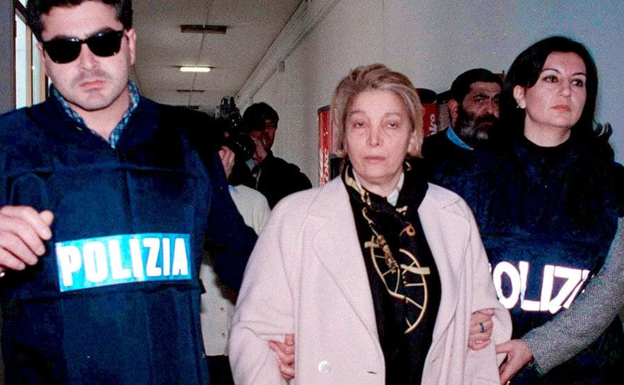 Pina being escorted by police on the day of her arrest. 