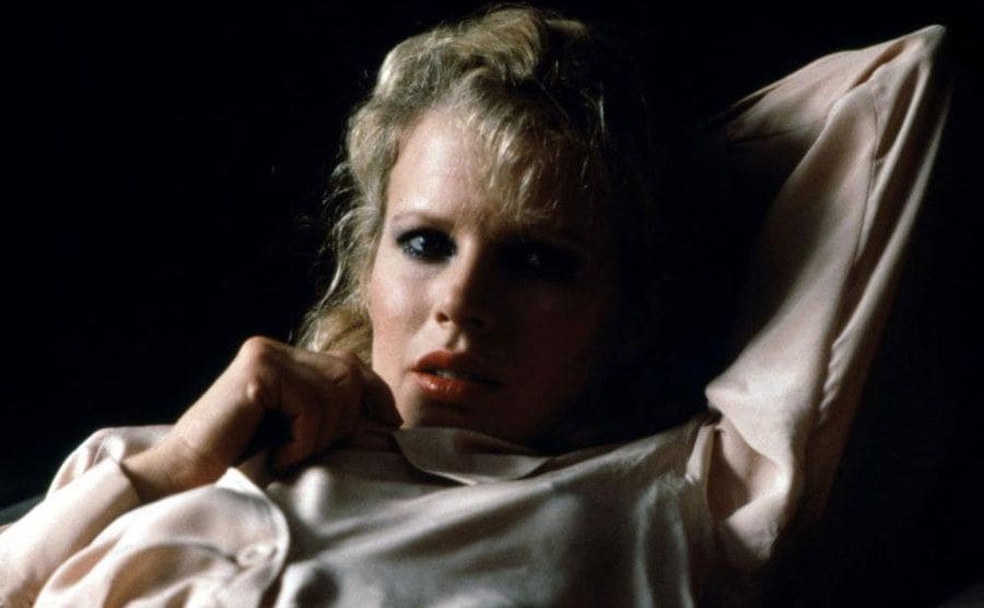 Kim Basinger as Elizabeth lying in bed in a scene from ‘9½ Weeks’.