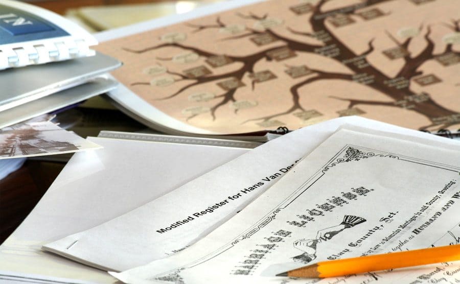 Investigating genealogy with the help of an old marriage license and a family tree.