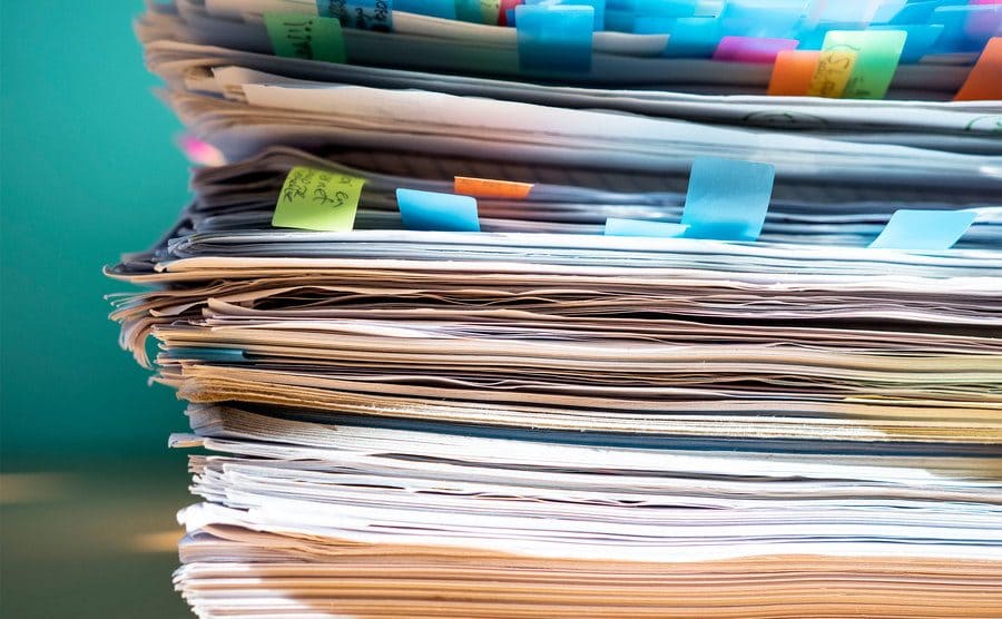 A pile of papers on a worktable.