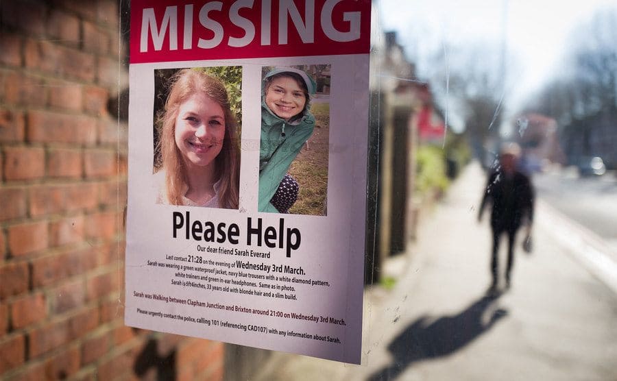 A flyer of a missing girl placed in a store window.