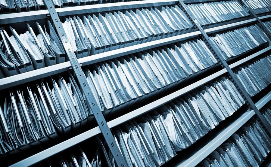 Shelves stacked with files and reports