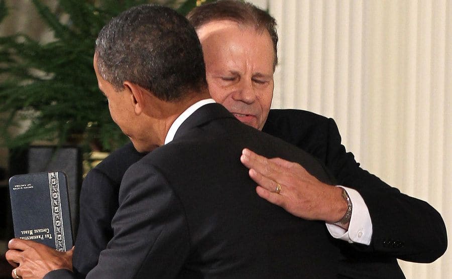 U.S. President Barack Obama hugs Roger Kemp after he presented him with a 2011 Presidential Citizens Medal.