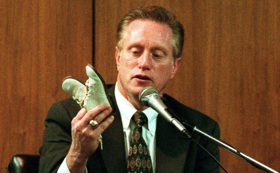 Joseph Burton testifies on the witness stand in court.