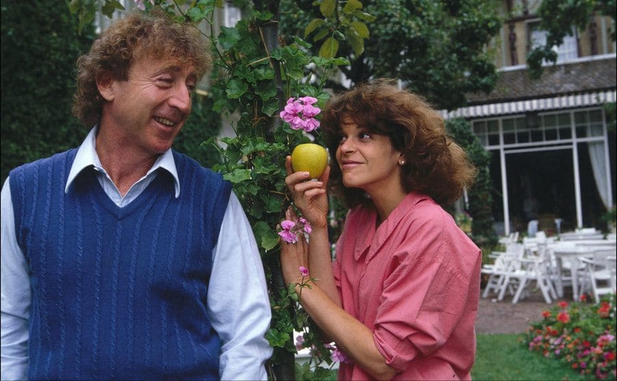 Gene and Gilda are being silly in their backyard.
