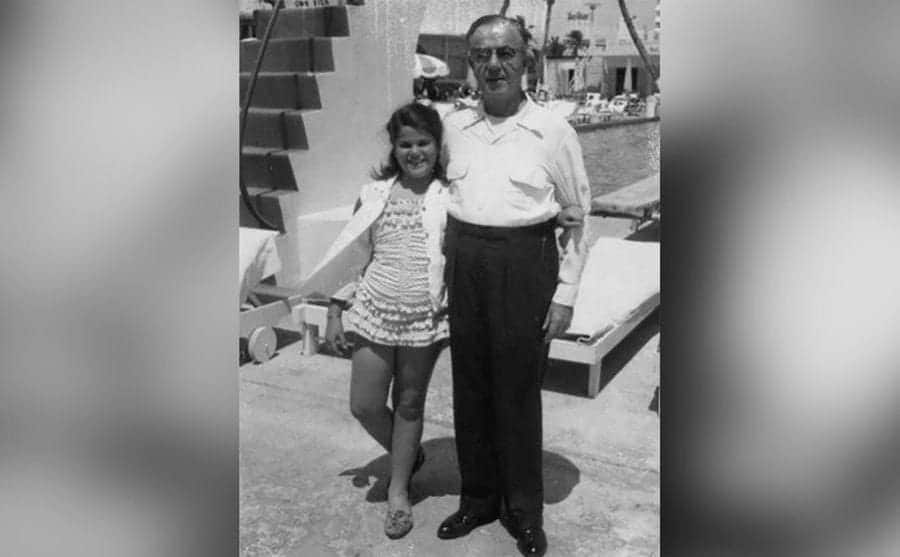 Little Gilda is posing with her father for a photo at the pool.
