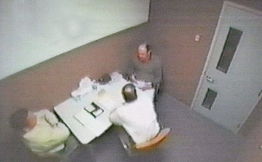 CCTV footage of investigators interviewing a suspect. 