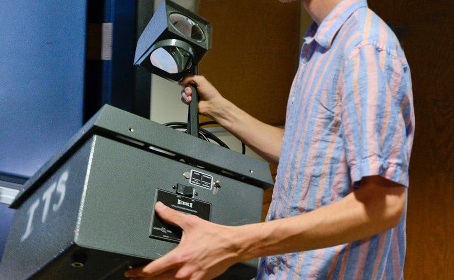Hands holding an overhead projector.