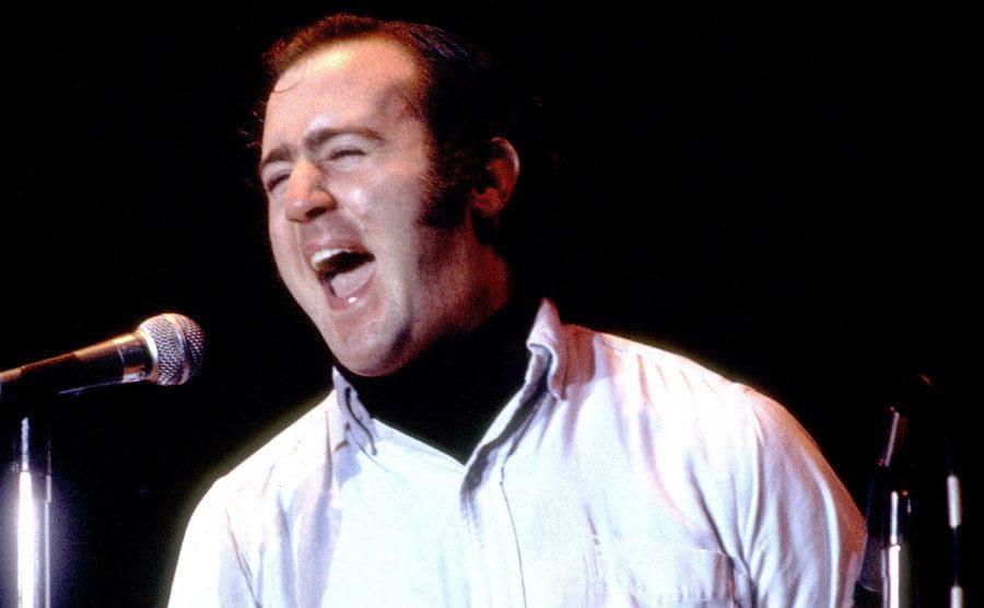 Andy Kaufman is about to show tears in his eyes during a performance on stage.
