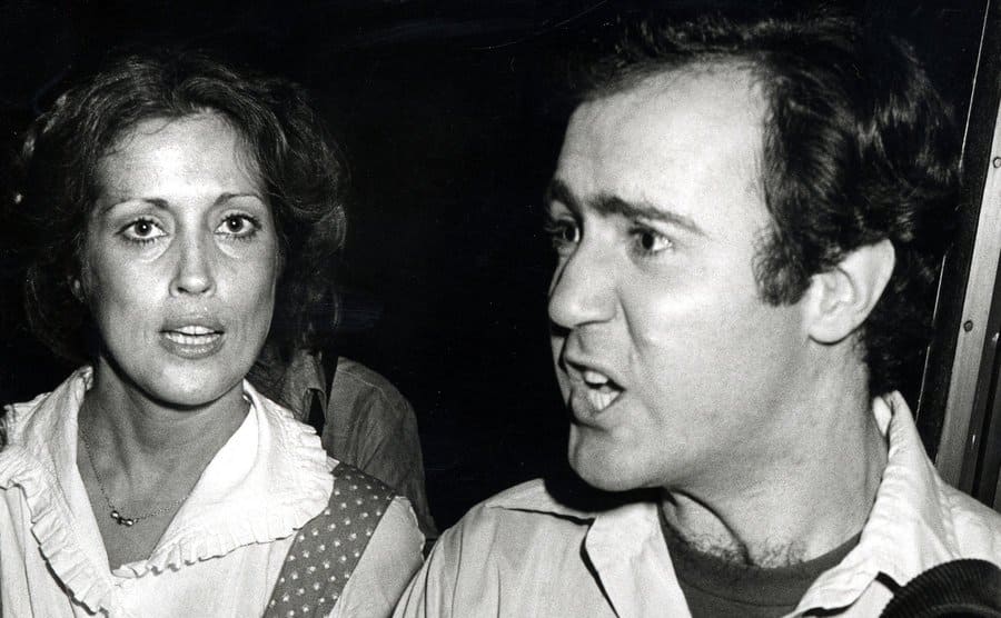 The press takes shots of Andy Kaufman and Charmagne Leland during