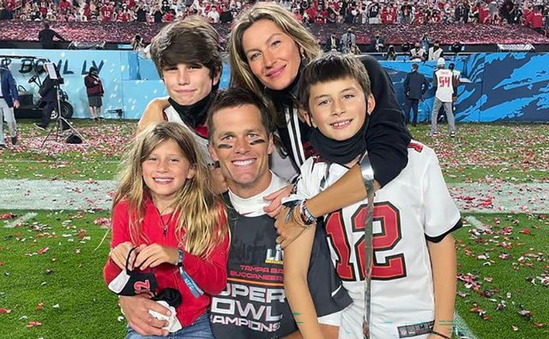 A happy family photo at the super bowl after the game.