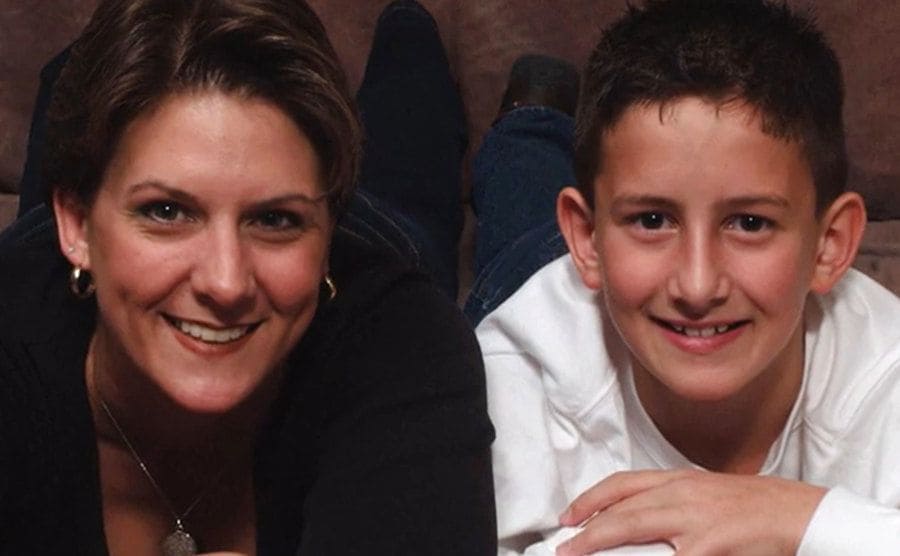 Old photo of Farver and her son smiling at the camera.