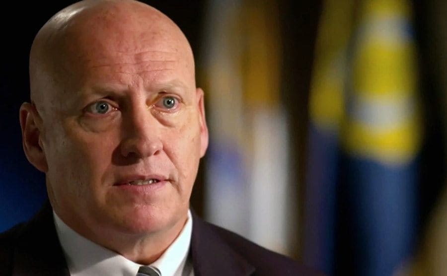 The detective is talking about the case during an interview on the news.
