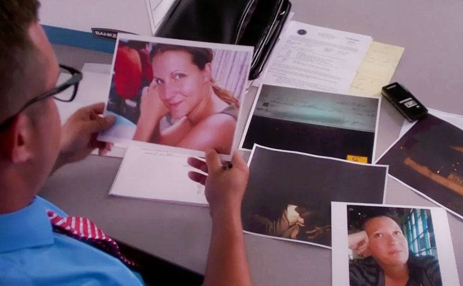 An investigators is sitting in the office looking at a photo of Carie Farver.