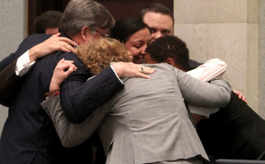 Casey Antony's defense team surrounded her in a group hug after the final verdict. 