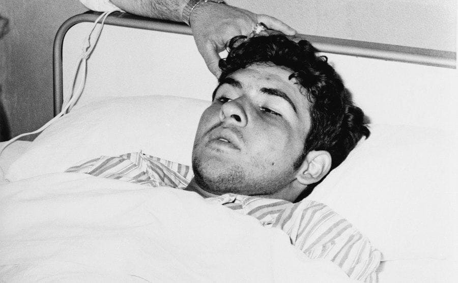 Adonis Guerrero Barrios in his hospital bed after he was found in the wheel well.
