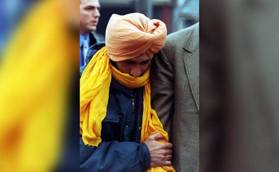 Pardeep Saini being escorted after his plane landed.