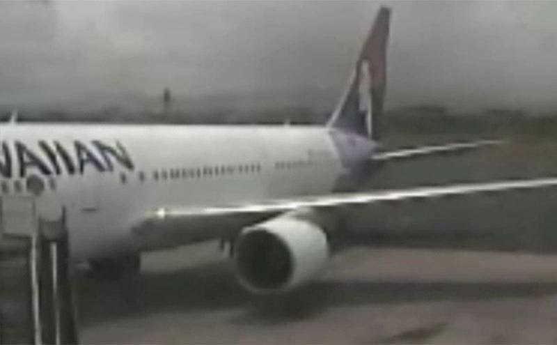 CCTV footage of a teen stowaway coming out of a grounded plane.