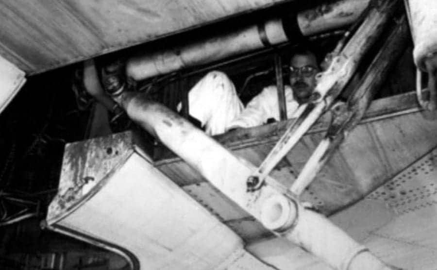 A man is hiding in the plane’s wheel well.