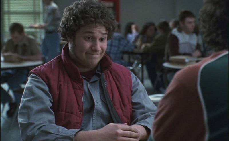Seth Rogen, as Ken Miller, sits in the school cafeteria.