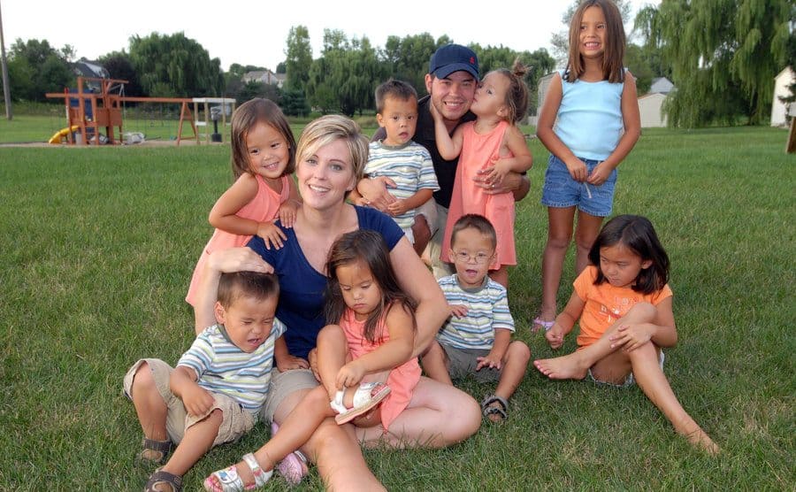 Jon and Kate are trying to take a sweet family photo with the kids while out at the park.
