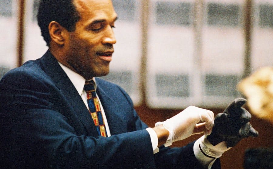 O.J. Simpson tries on a leather glove allegedly used in the murders of Nicole Brown and Ronald Goldman.
