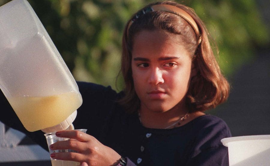 Sydney Simpson is standing outside during a lemonade sale.