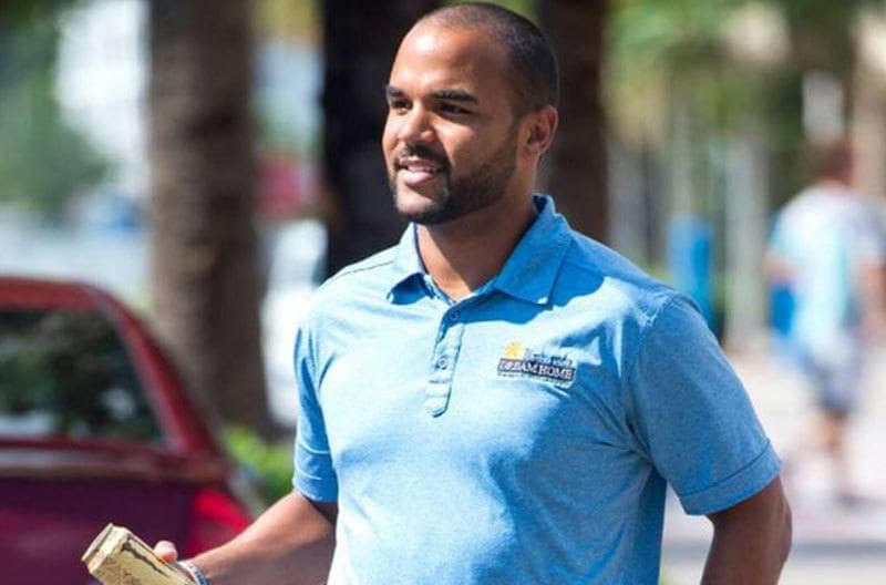 Justin Simpson is walking on the street.