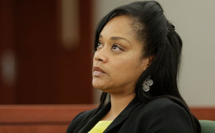 Arnelle Simpson is sitting in the courtroom.