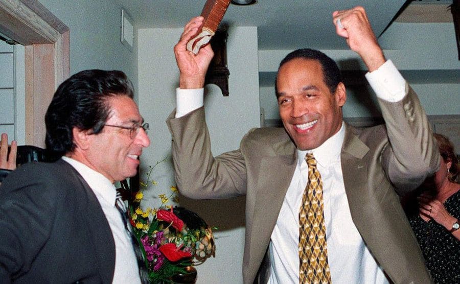 Robert Kardashian and O.J. Simpson are laughing and making jokes during a gathering.