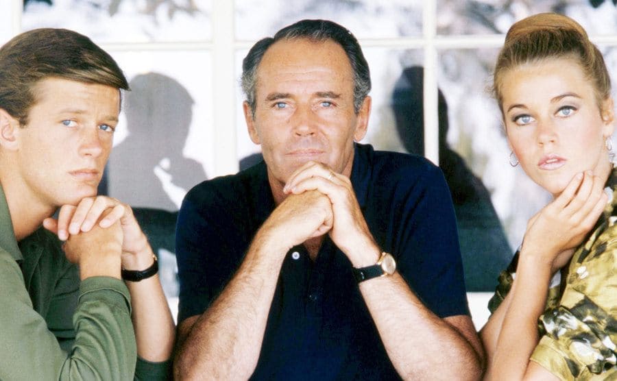 Peter Fonda, Henry Fonda, and Jane Fonda sit starring at the camera.