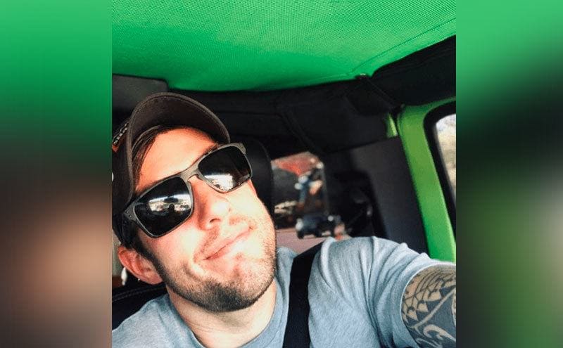 Kane takes a selfie in his Jeep.