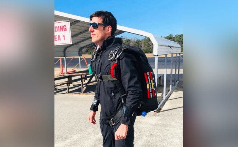 Kane gazes at the horizon after landing while wearing a special suit and a bag.