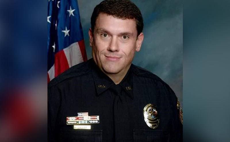 A portrait of Jason Collier wearing the Texas Police uniform.