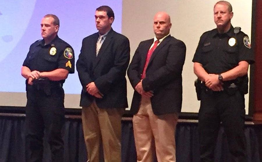 Jason Collier is standing next to other officers during a ceremony at police headquarters.