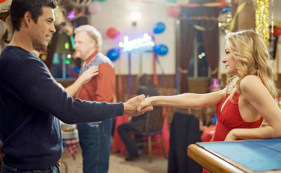 Eddie Cibrian and LeAnn Rimes shake hands in the movie set.