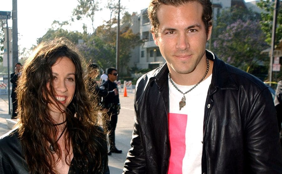 Alanis Morissette and Ryan Reynolds arrive at an event.